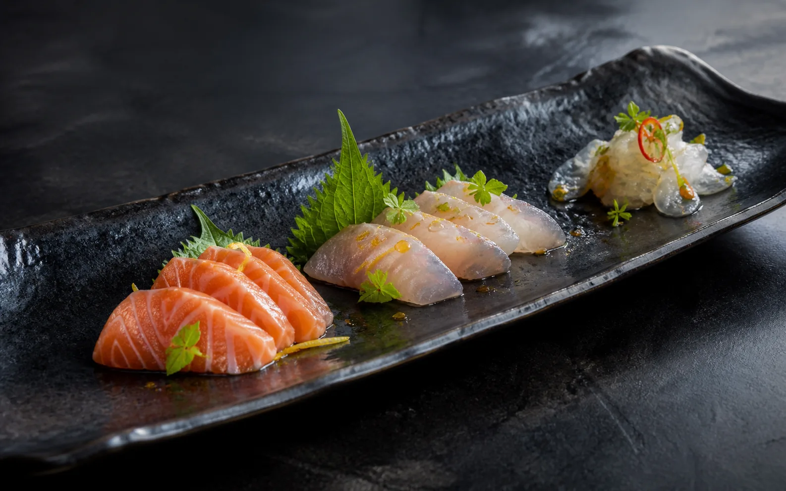 Concept preview of fresh sashimi with citrus, shiso and Thai herbs
