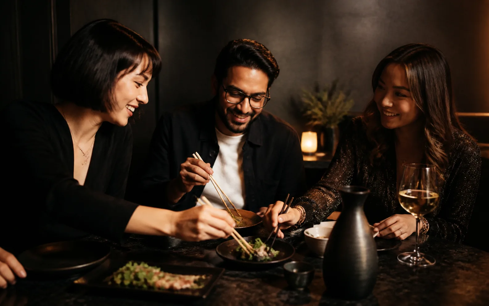 Concept preview of three friends sharing plates, sake and wine
